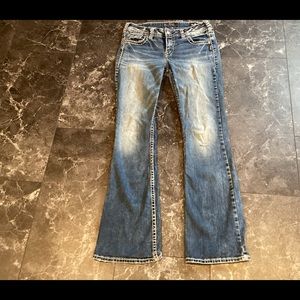 Silver Suki Mid Rise Boot Cut Distressed Jeans